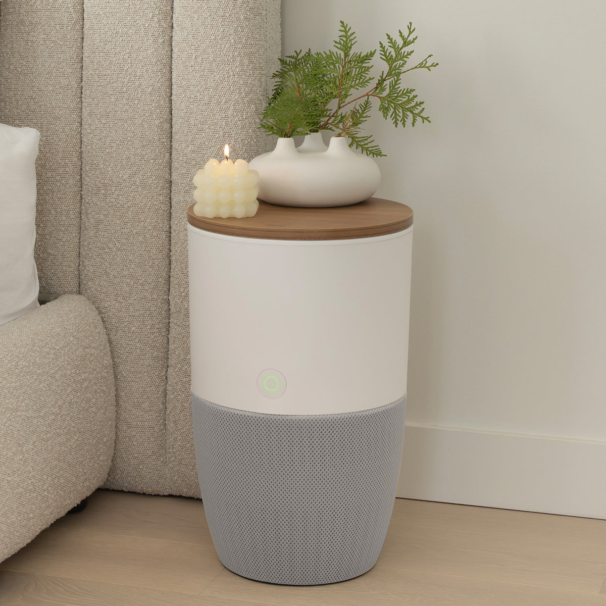 Bloom air purifier with walnut top used as an accent table next to a sofa