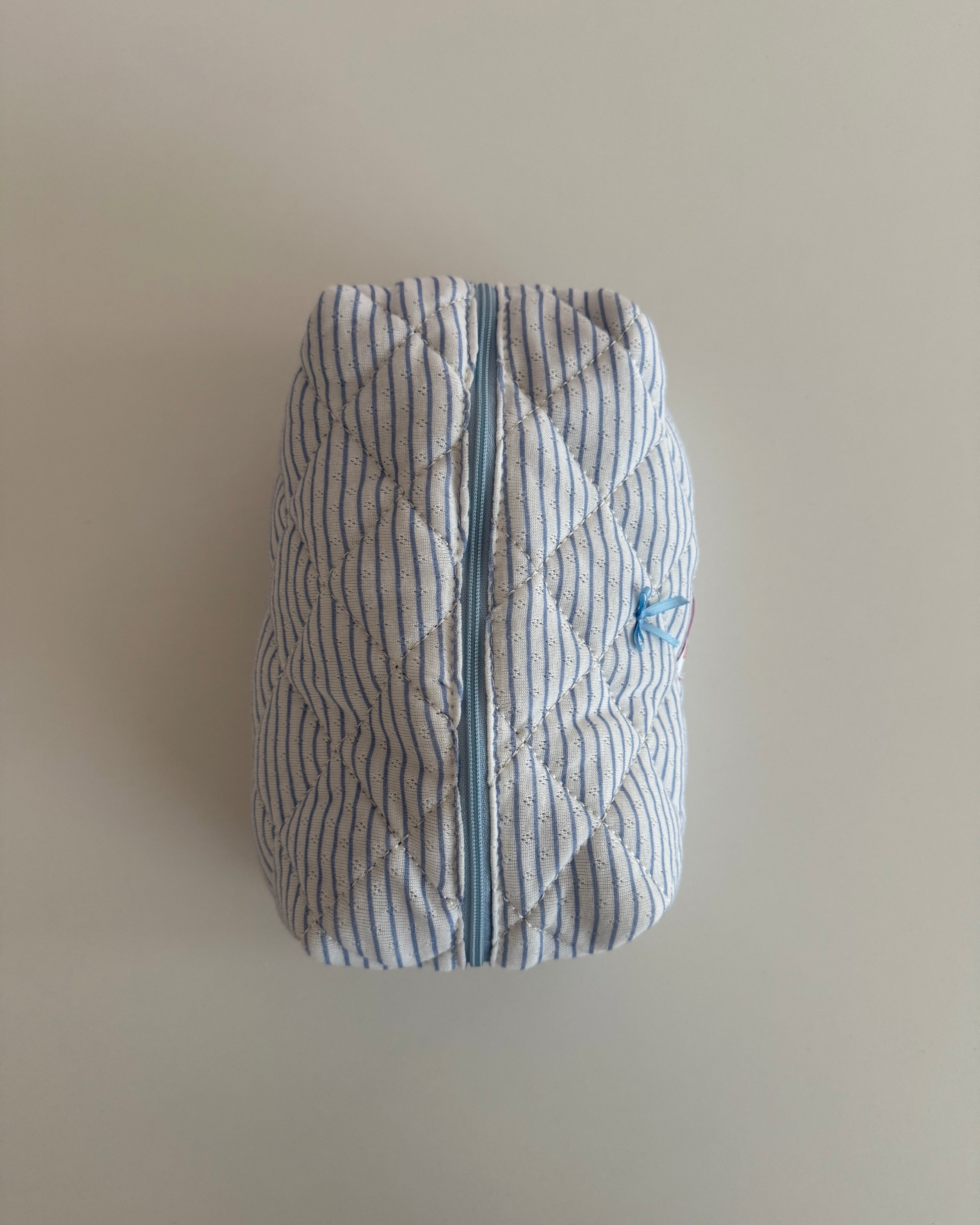 Trousse de maquillage bleu ligné