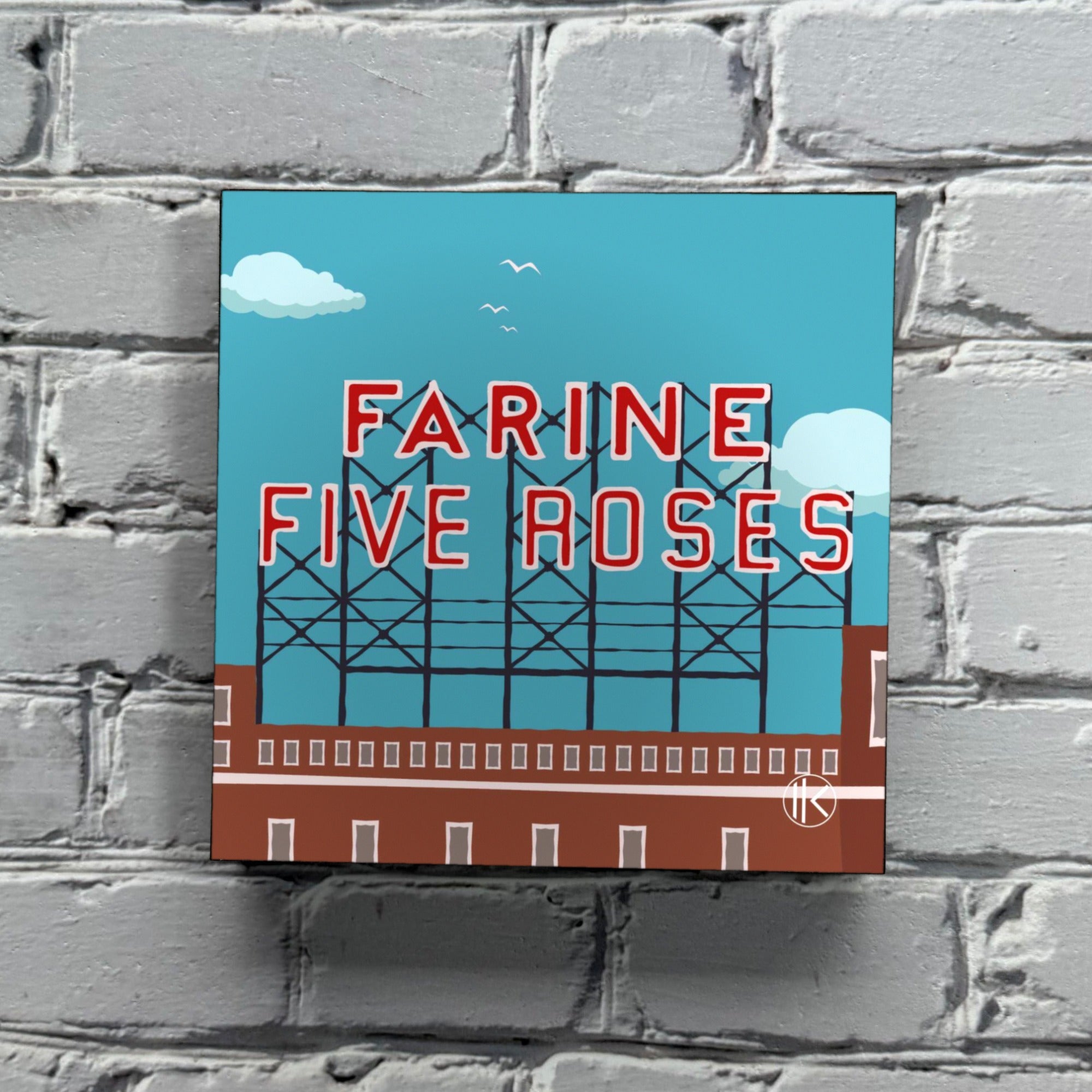 Ikon en bois « Farine Five Roses » de Fabrik Nordik accroché à un mur de brique blanche, montrant l'épaisseur du bloc de bois